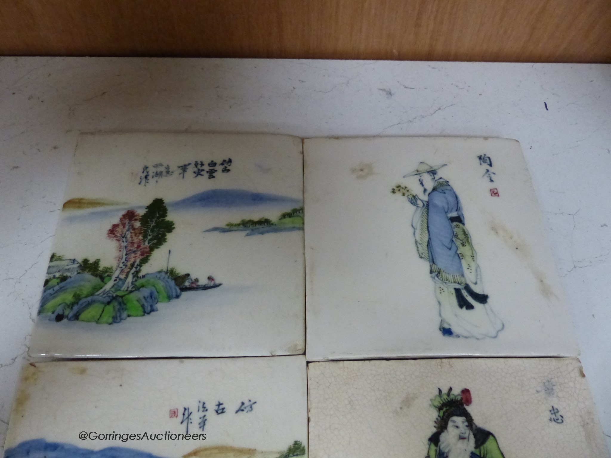 Four Chinese landscape tiles and four Chinese figurative tiles, 13cm square